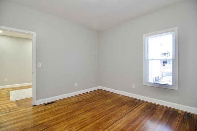 unfurnished room featuring hardwood / wood-style flooring