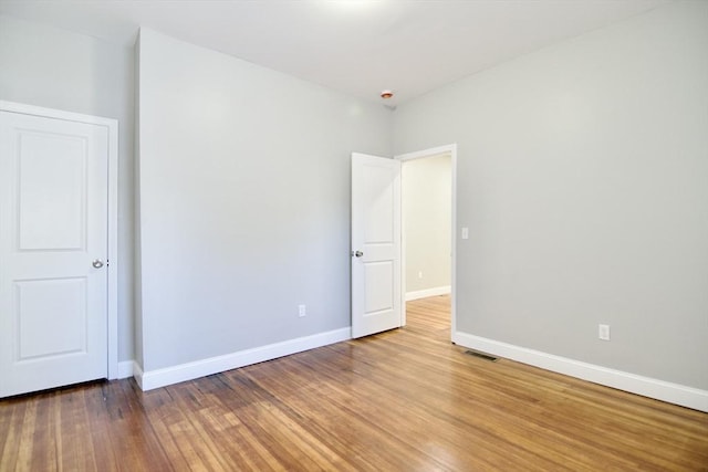 empty room featuring wood-type flooring