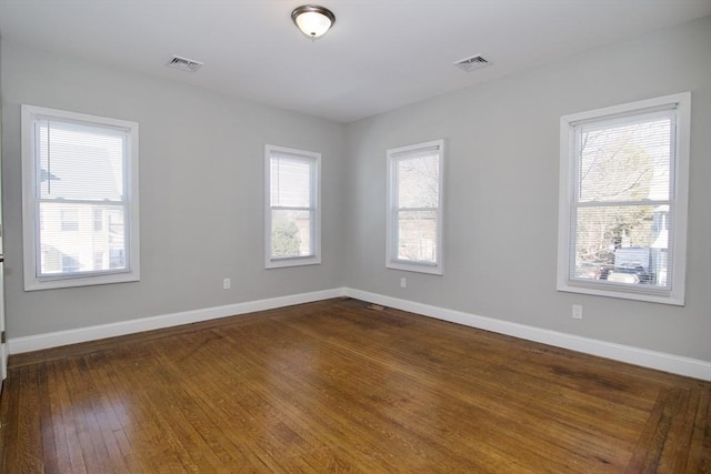 spare room featuring dark wood-type flooring