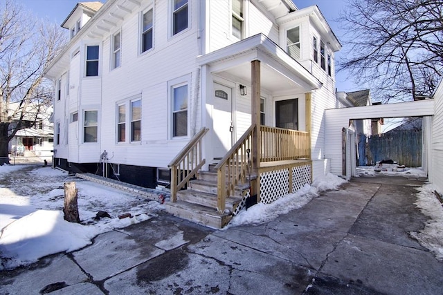 view of snow covered property entrance