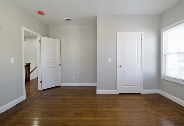 unfurnished bedroom featuring dark hardwood / wood-style floors