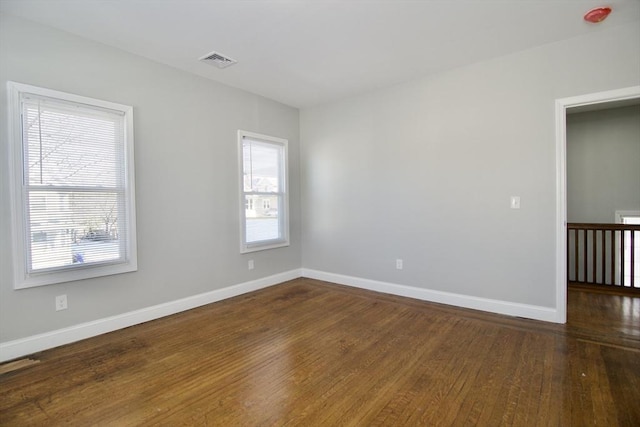 unfurnished room featuring dark hardwood / wood-style floors