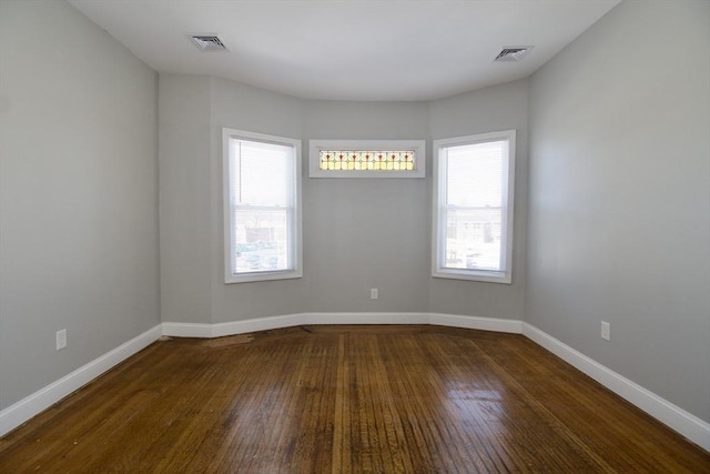 empty room featuring dark hardwood / wood-style flooring