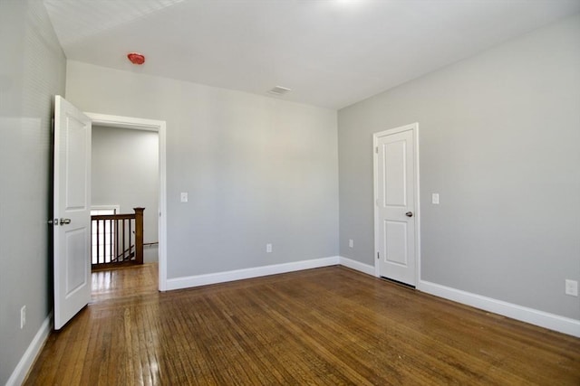 spare room with dark hardwood / wood-style flooring