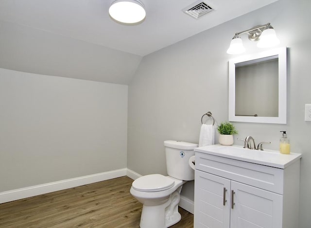 bathroom featuring lofted ceiling, wood-type flooring, toilet, and vanity