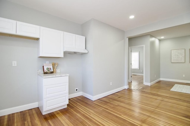 kitchen featuring white cabinetry and light hardwood / wood-style floors