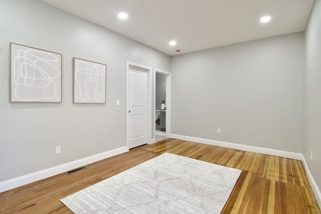 unfurnished room featuring hardwood / wood-style flooring