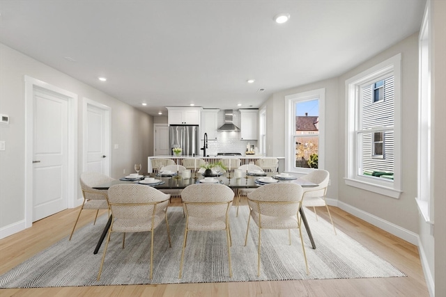 dining room with light hardwood / wood-style floors and sink