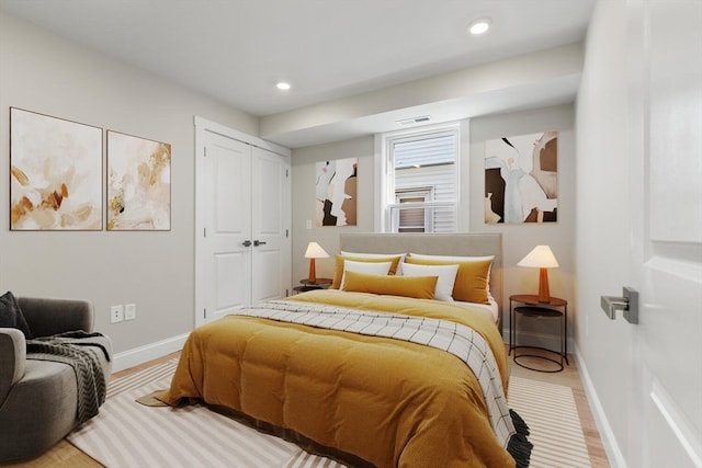 bedroom with hardwood / wood-style floors and a closet