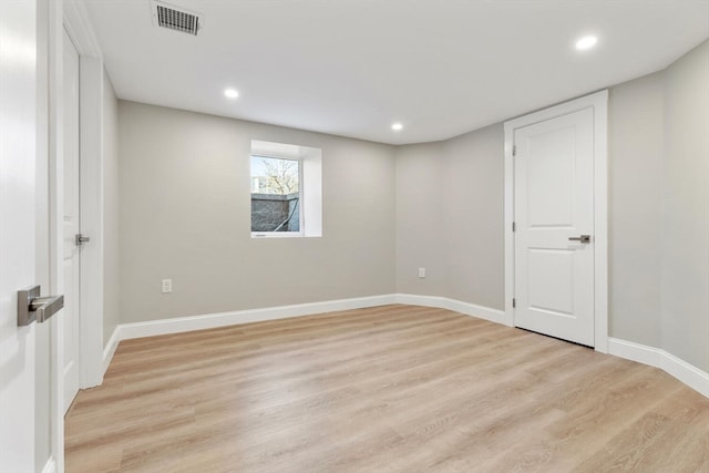 unfurnished room with light hardwood / wood-style floors