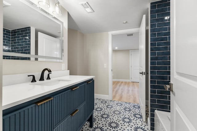 bathroom with a shower, vanity, and hardwood / wood-style flooring