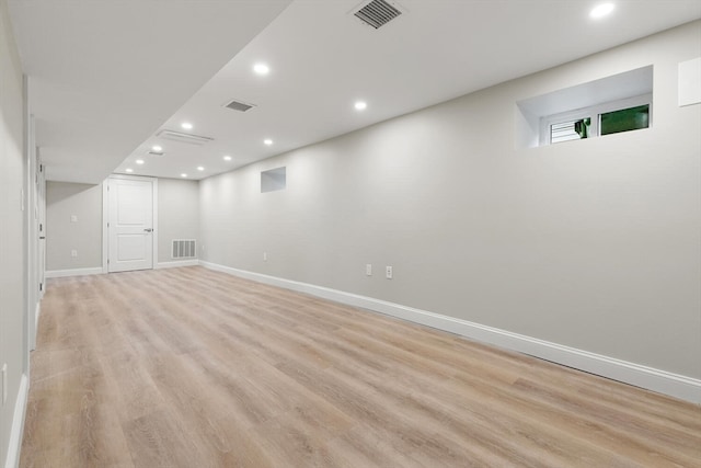 basement with light hardwood / wood-style floors