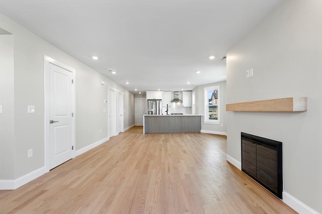 unfurnished living room with light wood-type flooring