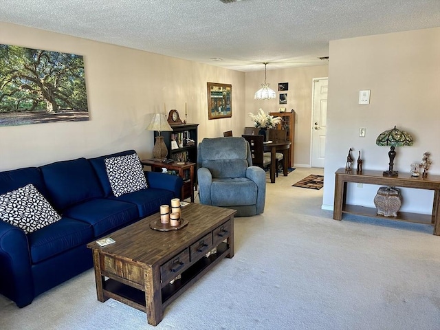 living area featuring light carpet and a textured ceiling