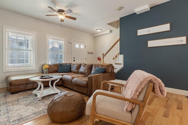 living room featuring ceiling fan and light hardwood / wood-style floors