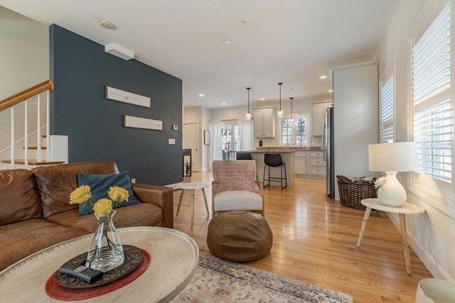 living room featuring plenty of natural light and light hardwood / wood-style floors