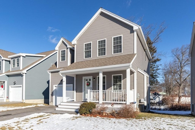 view of front of property with a porch and a garage