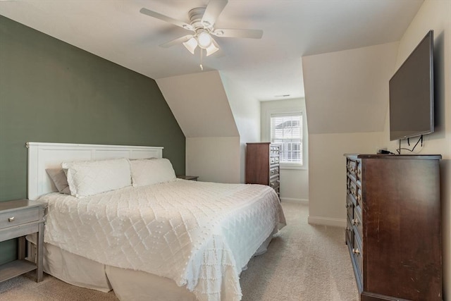 carpeted bedroom with vaulted ceiling and ceiling fan