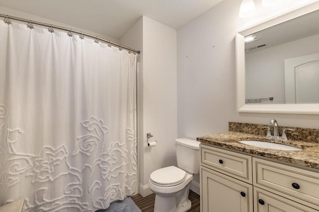 bathroom with vanity, wood-type flooring, and toilet