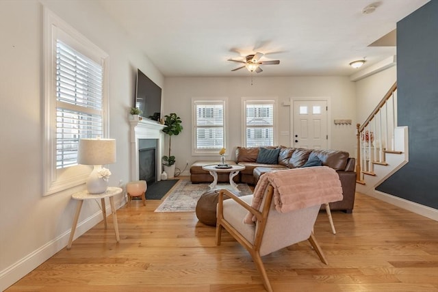 living room featuring ceiling fan and light wood-type flooring