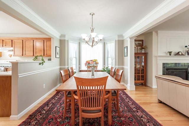 21 Harbor Mist Dr Unit 21, Fairhaven, MA 02719 - dining area featuring crown molding, a chandelier, light wood finished floors, and a high end fireplace