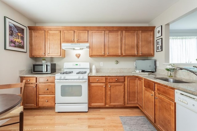 21 Harbor Mist Dr Unit 21, Fairhaven, MA 02719 - kitchen featuring white appliances, under cabinet range hood, brown cabinets, and light wood-style floors