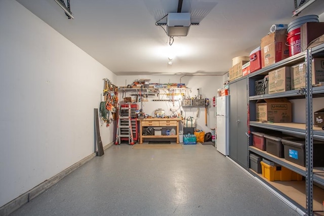 21 Harbor Mist Dr Unit 21, Fairhaven, MA 02719 - garage with a garage door opener and freestanding refrigerator