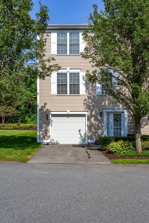 21 Harbor Mist Dr Unit 21, Fairhaven, MA 02719 - view of front facade with asphalt driveway, an attached garage, and a front yard