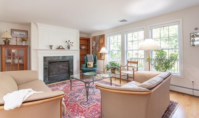 21 Harbor Mist Dr Unit 21, Fairhaven, MA 02719 - living room with light wood-style floors, a high end fireplace, and a baseboard radiator