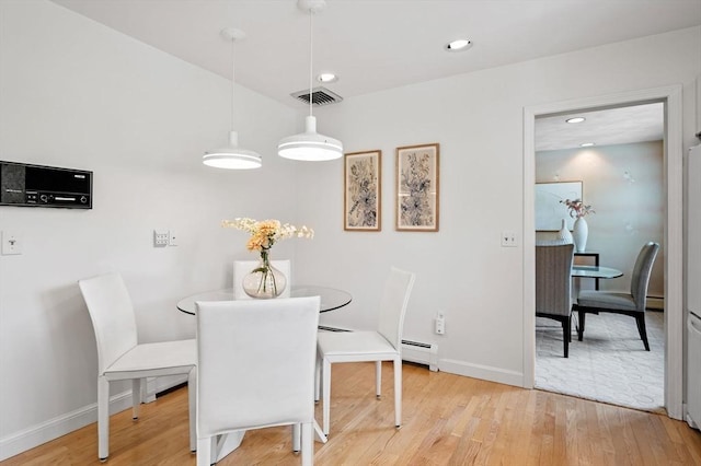 dining room featuring a baseboard radiator, recessed lighting, baseboards, light wood finished floors, and visible vents