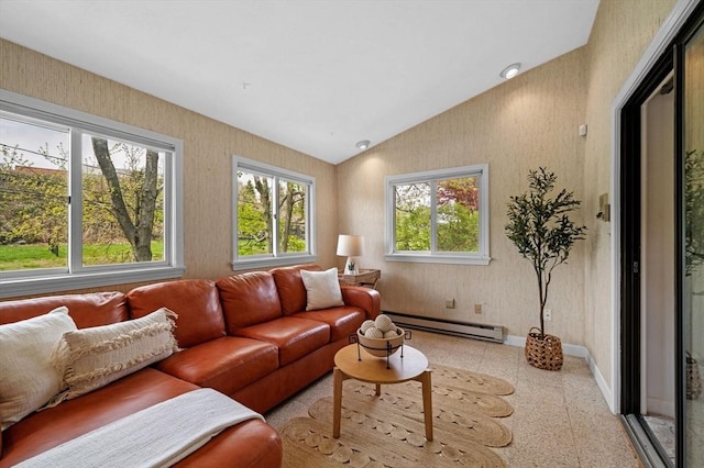 living room featuring a baseboard heating unit, lofted ceiling, and baseboards