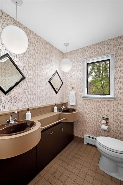 bathroom featuring toilet, wallpapered walls, tile patterned floors, a baseboard heating unit, and vanity