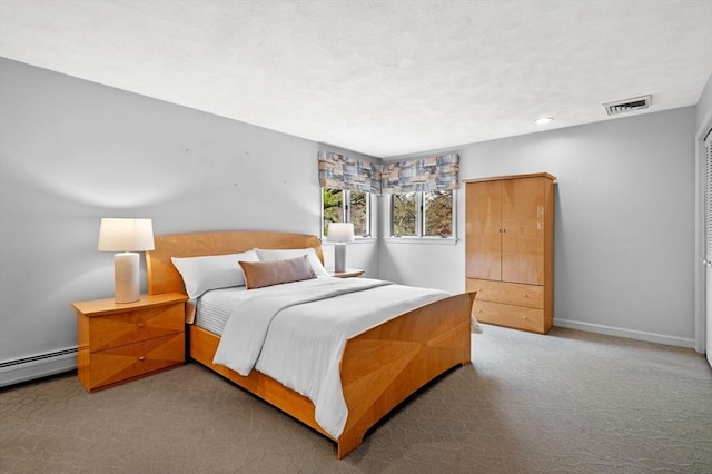 bedroom featuring carpet flooring, visible vents, baseboards, and a baseboard heating unit