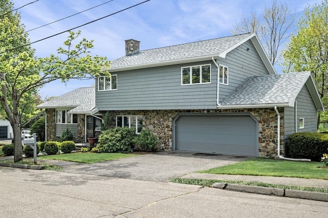 view of front of house featuring roof with shingles, a chimney, stone siding, and driveway