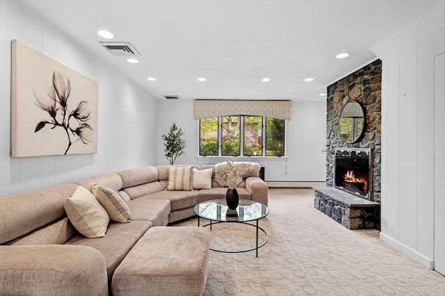 living room featuring baseboards, a stone fireplace, visible vents, and recessed lighting