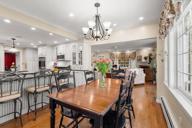 4 Crestwood, Marblehead, MA 01945 - dining room with light wood-type flooring, recessed lighting, ornamental molding, a chandelier, and a baseboard radiator