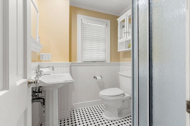 4 Crestwood, Marblehead, MA 01945 - bathroom featuring a wainscoted wall, toilet, ornamental molding, and a sink
