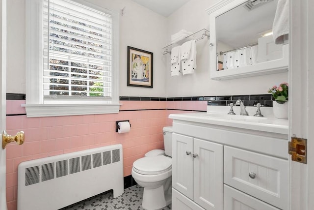 4 Crestwood, Marblehead, MA 01945 - bathroom with radiator heating unit, tile walls, vanity, toilet, and a wainscoted wall