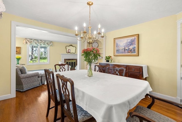 4 Crestwood, Marblehead, MA 01945 - dining space with baseboards, wood finished floors, a chandelier, and a fireplace