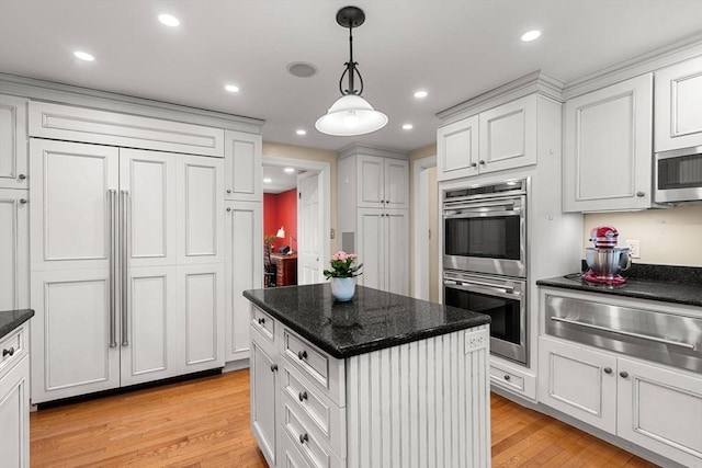 4 Crestwood, Marblehead, MA 01945 - kitchen with appliances with stainless steel finishes, a warming drawer, light wood-style flooring, decorative light fixtures, and white cabinetry