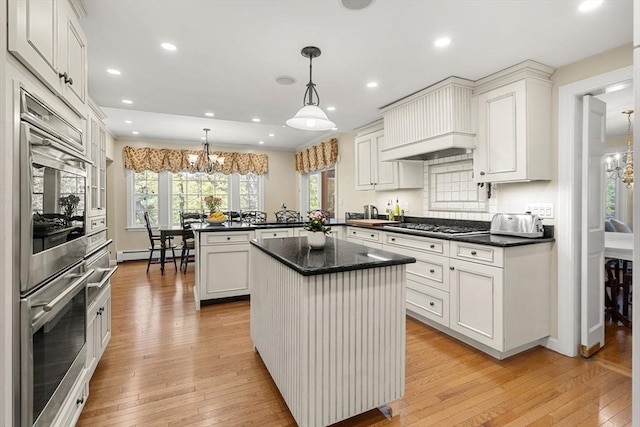 4 Crestwood, Marblehead, MA 01945 - kitchen featuring a chandelier, a peninsula, light wood-style floors, a baseboard radiator, and recessed lighting