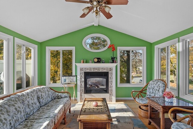 sunroom featuring vaulted ceiling, a high end fireplace, and ceiling fan