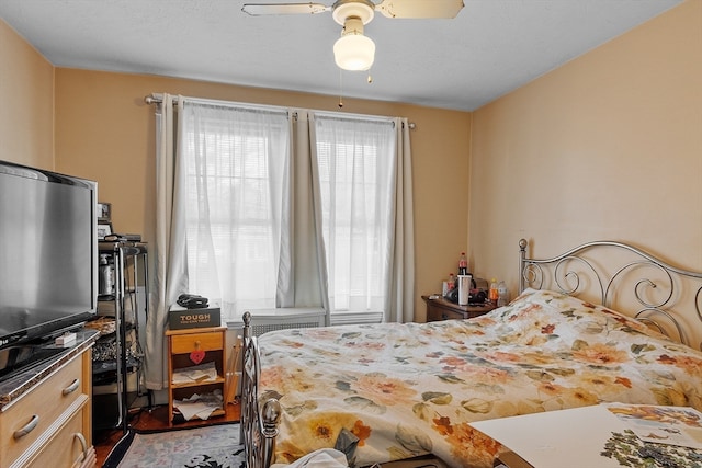 bedroom featuring dark hardwood / wood-style flooring and ceiling fan