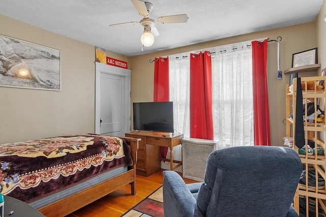 bedroom featuring a textured ceiling, hardwood / wood-style flooring, and ceiling fan