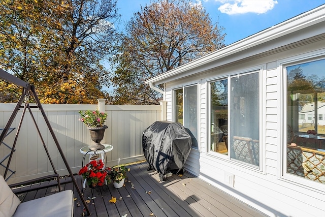 wooden terrace featuring a grill