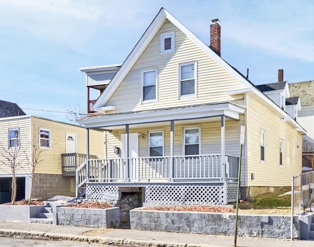 view of front of house with covered porch and a chimney