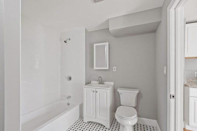 bathroom with baseboards, toilet,  shower combination, and vanity