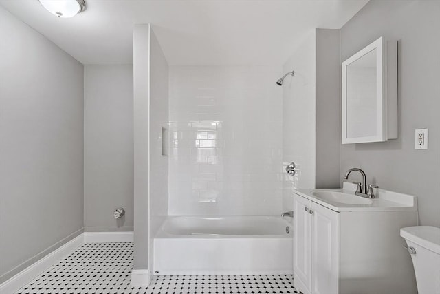 full bathroom featuring baseboards, toilet, vanity, and washtub / shower combination