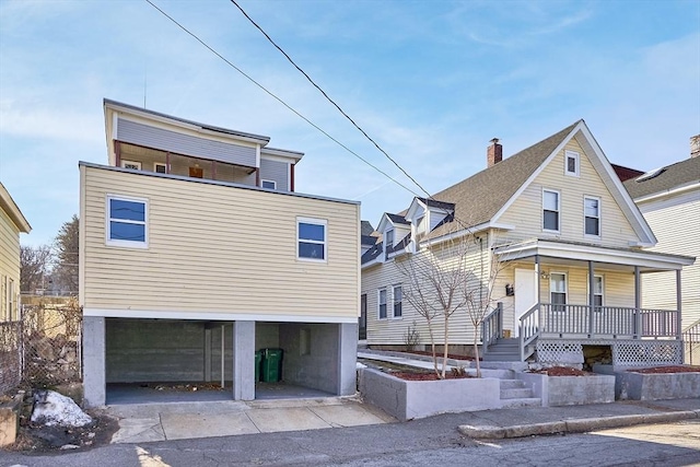 view of front of property featuring an attached garage, a porch, and driveway