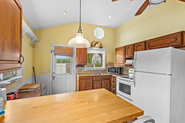 49 Boathouse Rd, Groton, MA 01450 - kitchen with white appliances, healthy amount of natural light, ceiling fan, vaulted ceiling, and brown cabinetry